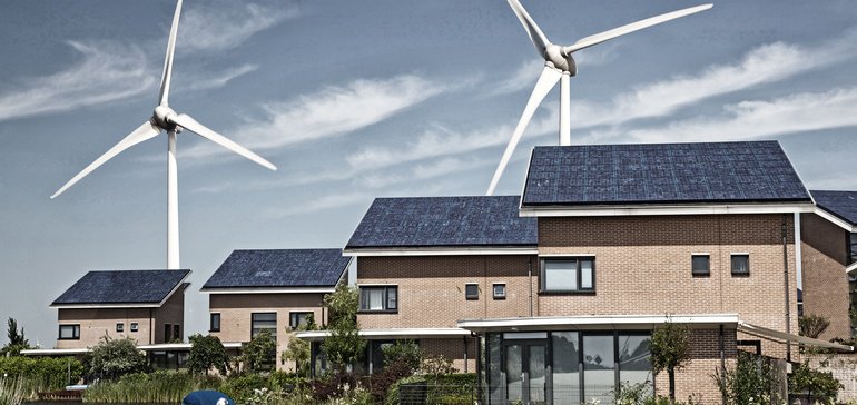 wind turbines behind houses