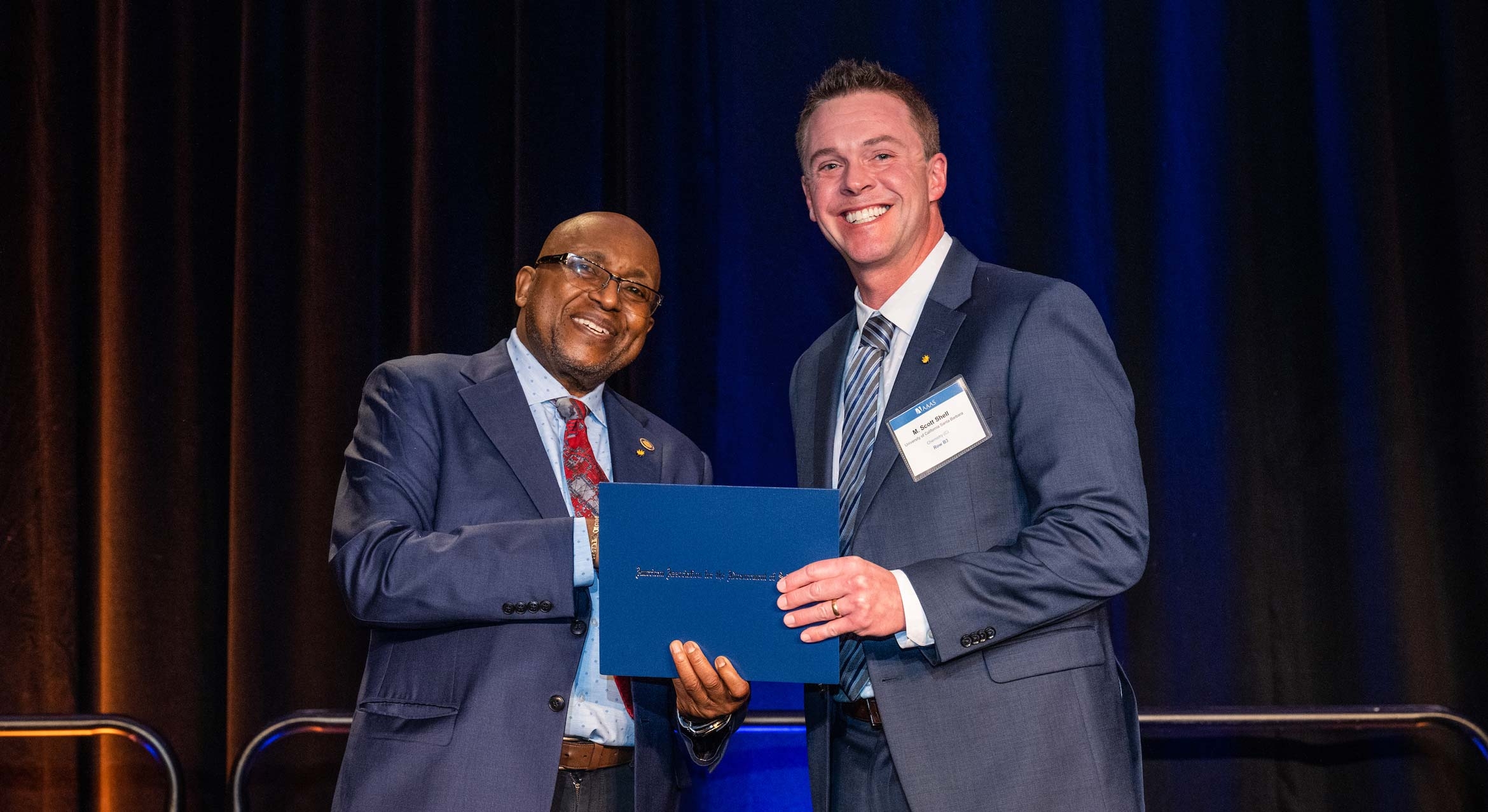 Willie E. May, left, president of the American Association for the Advancement of Science, inducts chemical engineering professor M. Scott Shell, right, as a Fellow.