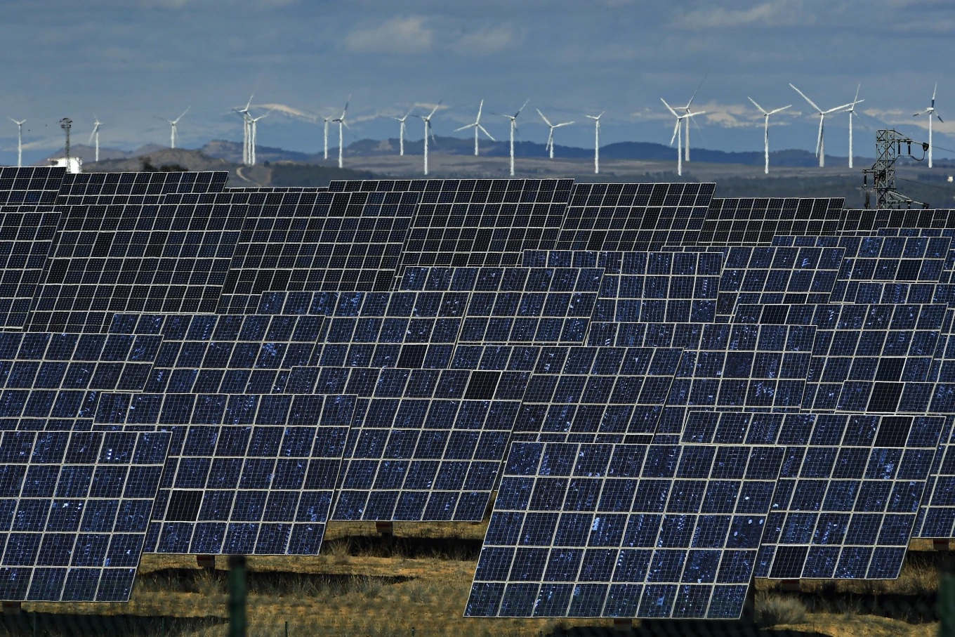 Solar panels work near the small town of Milagro, Navarra Province, northern Spain, Feb. 24, 2023. (AP Photo/Alvaro Barrientos)