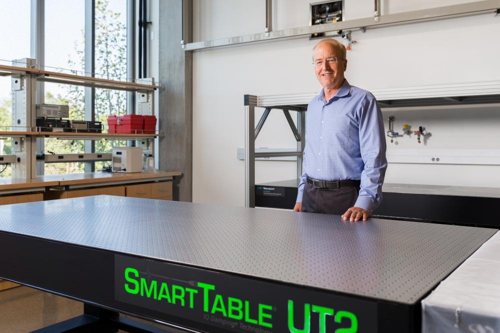 John Bowers behind a smart desk in his IEE lab