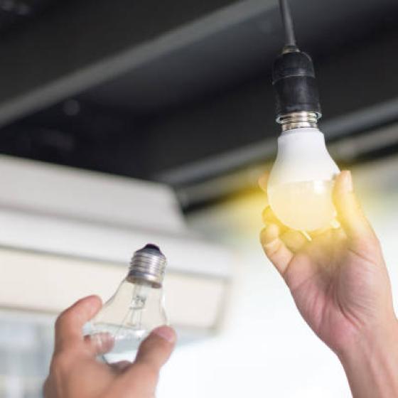 istockphoto of an incadescent light bulb being replaced by an LED bulb