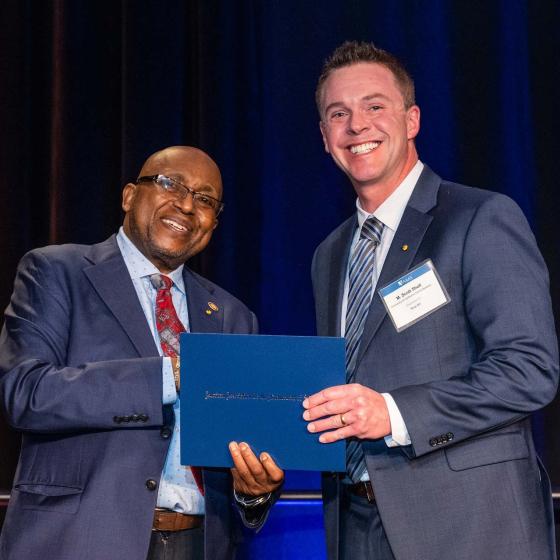 Willie E. May, left, president of the American Association for the Advancement of Science, inducts chemical engineering professor M. Scott Shell, right, as a Fellow.