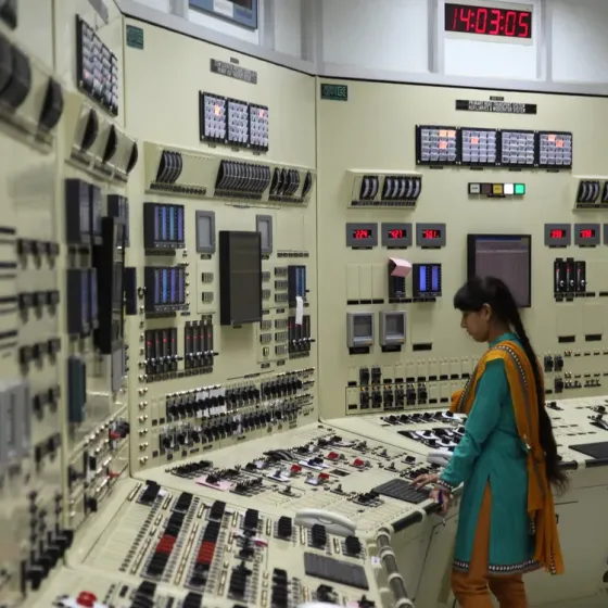 indian woman standing in the control room of a nuclear power plant